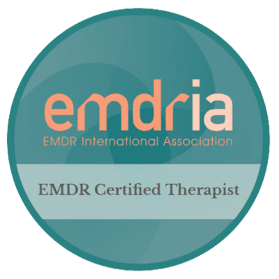 Round logo featuring blue and orange colors, displaying the text "EMDRIA EMDR International Association EMDR Certified Therapist" in a circular format.