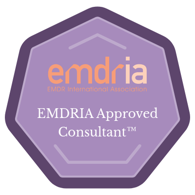 A purple hexagon featuring white text that reads "emdria EMDR International Association EMDRIA Approved Consultant™".